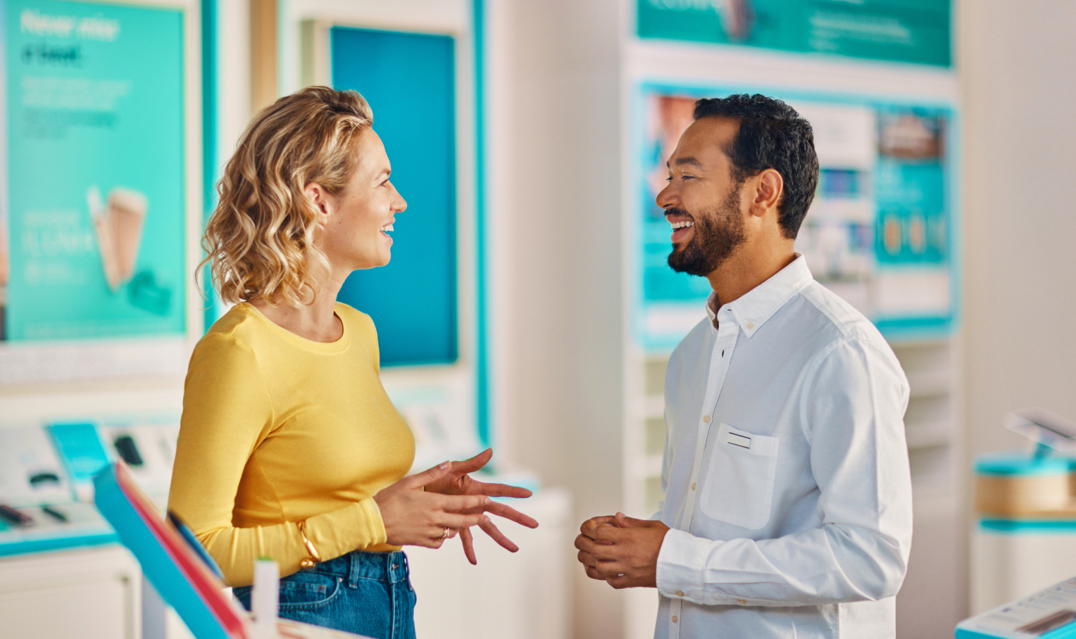 Two people conversing in IQOS store