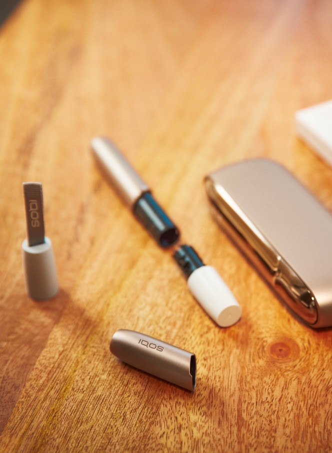 Man cleaning his IQOS holder